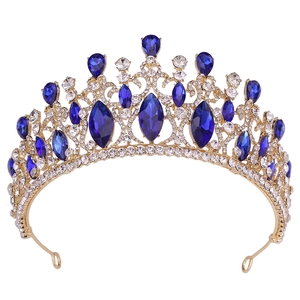 Detail of baroque gold crown with deep blue crystals and rhinestones for brides