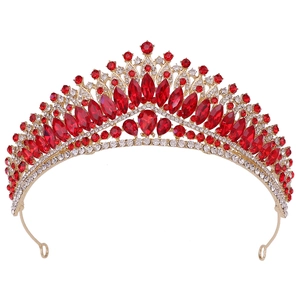 Macro detail of luxury baroque bridal crown with red crystals and gold metal setting