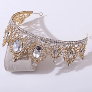 Detail of baroque bridal crown showing golden alloy base with rhinestones and large crystals