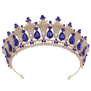 Macro detail of golden bridal tiara with blue teardrop stones and white micro-diamonds