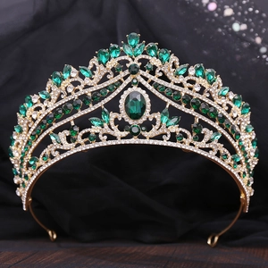 Close-up of luxury bridal crown with emerald green stones and sparkling rhinestones