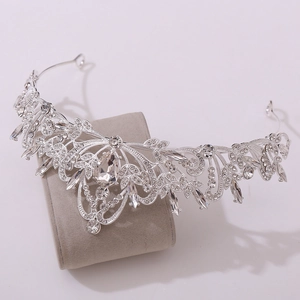 Close-up of silver bridal crown showing detailed rhinestones and crystal leaf patterns
