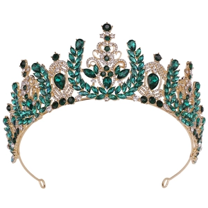 Close-up of golden barley spike bridal crown with emerald crystals and rhinestones