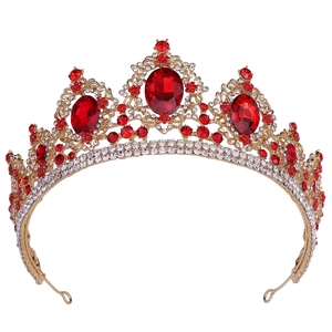 Macro detail of Baroque bridal crown with red rhinestones and gold alloy texture