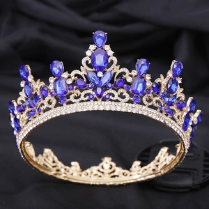 Close-up of luxury gold bridal crown featuring dark blue crystals and white rhinestones
