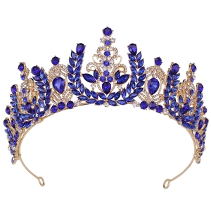 Detail of golden baroque tiara featuring deep blue pear-shaped crystals and fine diamonds