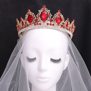Macro detail of Baroque bridal crown with red gemstones and crystals on white model