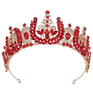 Macro detail of Baroque bridal crown with red gems and crystal wheat ear patterns