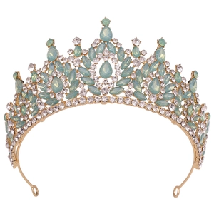Close-up of golden bridal crown with pale green opals and small white crystals