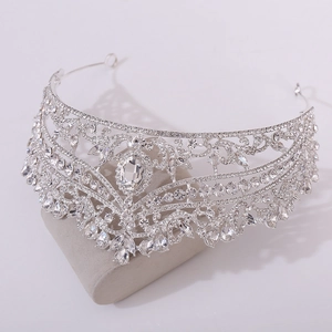 Close-up of silver bridal tiara with sparkling crystal rhinestones and hollow patterns