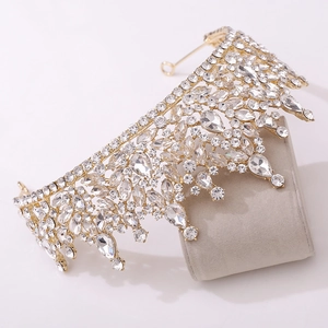 Detailed macro view of crystal rhinestones on a gold baroque bridal crown for queens