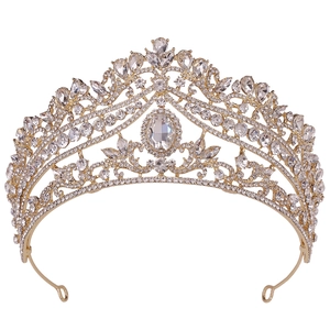 Close-up of golden bridal crown with sparkling rhinestones and oval center stone