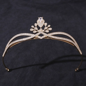 Detail of a golden bridal crown with sparkling teardrop crystals and elegant leaf motifs