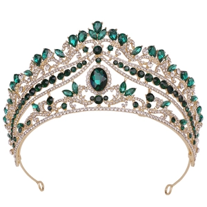 Detailed view of Baroque bridal crown with emerald green gems and sparkling rhinestones