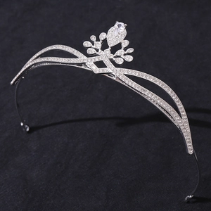 Close-up of silver crown headband with sparkling zircons and water drop pendant