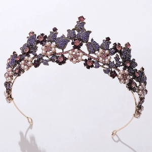Detailed macro shot of vintage gold bridal crown with purple crystals and white pearls