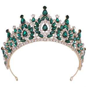Detailed macro of Baroque bridal crown with gold plating and green crystal gemstones