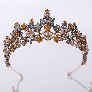 Close-up of golden bridal crown featuring amber crystals, pearls and intricate floral details