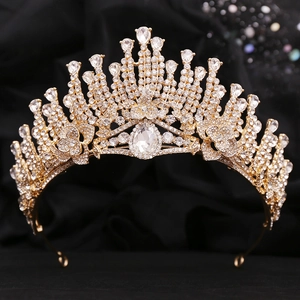 Close-up of gold bridal tiara with sparkling white crystals and pear-cut centerpiece