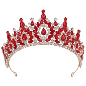 Close-up of Baroque gold crown with sparkling red and white crystals for bridal hair