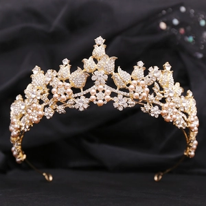 Close-up of golden bridal tiara featuring champagne pearls and sparkling crystals
