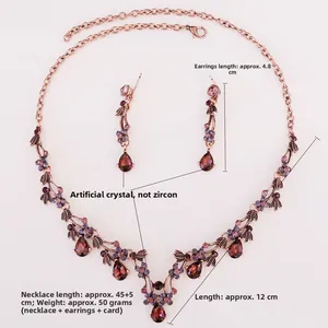 Detail of vintage bronze bridal jewelry set with red teardrop and purple crystals