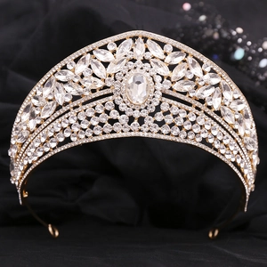 Exquisite gold bridal crown with sparkling crystals on black velvet background