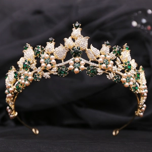 Close-up of golden bridal crown with emerald green crystals and cream pearls
