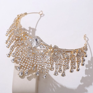 Close-up of golden bridal crown with sparkling crystal rhinestones and teardrop details