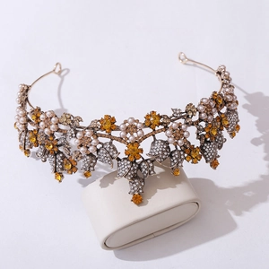 Detailed close-up of bridal headband with orange gems, pearls and floral crystals
