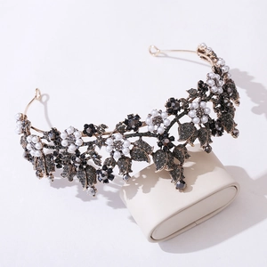Macro detail of vintage floral bridal tiara with pearls and grey crystals on a cushion