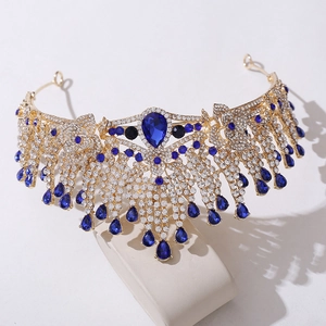 Detail of golden bridal crown with blue teardrop crystals and white rhinestones