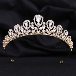 Close-up of gold bridal tiara with sparkling rhinestones and a pear-shaped center stone