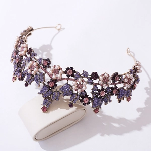 Detailed view of the vintage bridal crown featuring purple crystals and white pearls