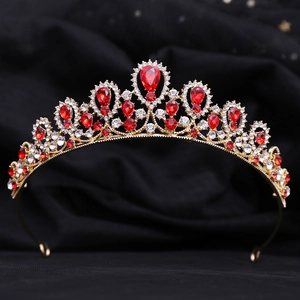 Detail of bohemian gold crown with red water-drop rhinestones on black satin