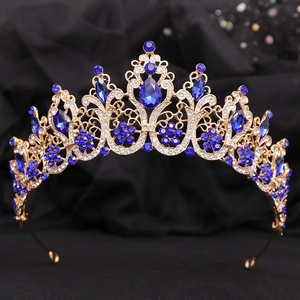 Detailed view of the gold baroque bridal crown with blue crystals and intricate engravings