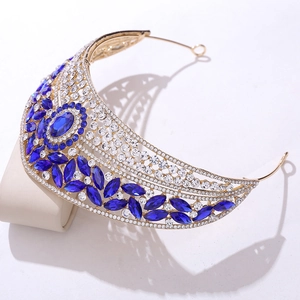 Detail of luxury bridal crown featuring large royal blue stones and gold alloy frame