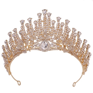 Close-up of golden bridal crown with pear-shaped crystal and intricate rhinestone setting
