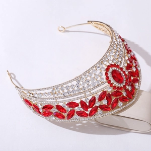 Detail of golden bridal crown featuring red oval stones and sparkling rhinestones