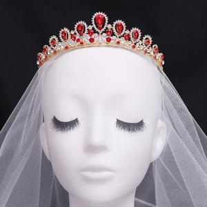 Elegant gold bridal tiara with teardrop red rhinestones and crystals on white veil