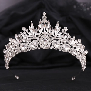 Macro view of baroque bridal crown with leaf crystals on elegant black silk background