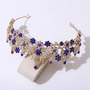 Regal gold bridal tiara with deep blue crystals, pink pearls, and floral rhinestones