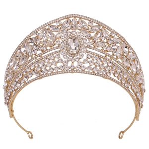 Close-up of luxury gold bridal crown with oval crystal centerpiece and rhinestones
