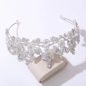 Close-up of bridal headband with silver alloy flowers, white pearls, and sparkling rhinestones