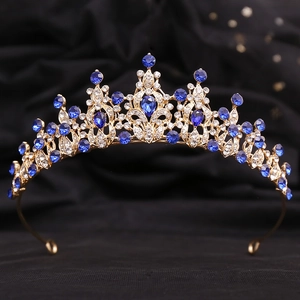 Detail of a gold bridal crown with marquise blue crystals and clear rhinestones