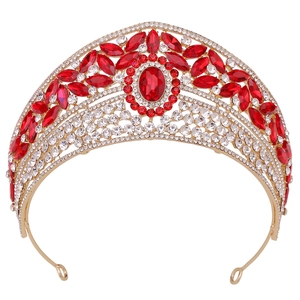 Detailed view of bridal crown featuring red teardrop rhinestones on golden alloy base