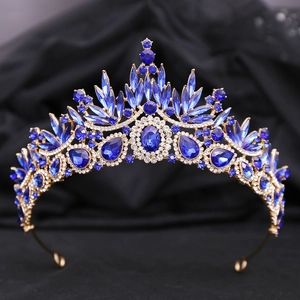Close-up of golden leaf crown with deep blue crystals and rhinestones for bridal