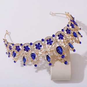 Detail of a Baroque bridal crown with blue teardrop crystals and gold floral filigree