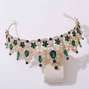 Detail of gold baroque bridal crown with emerald green stones and crystal accents