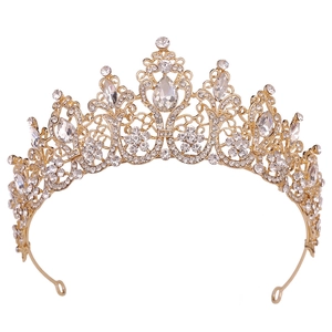 Detailed view of golden baroque bridal crown with crystal flower pattern and drop rhinestones
